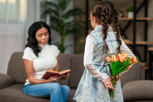 Girl surprising her teacher with flowers