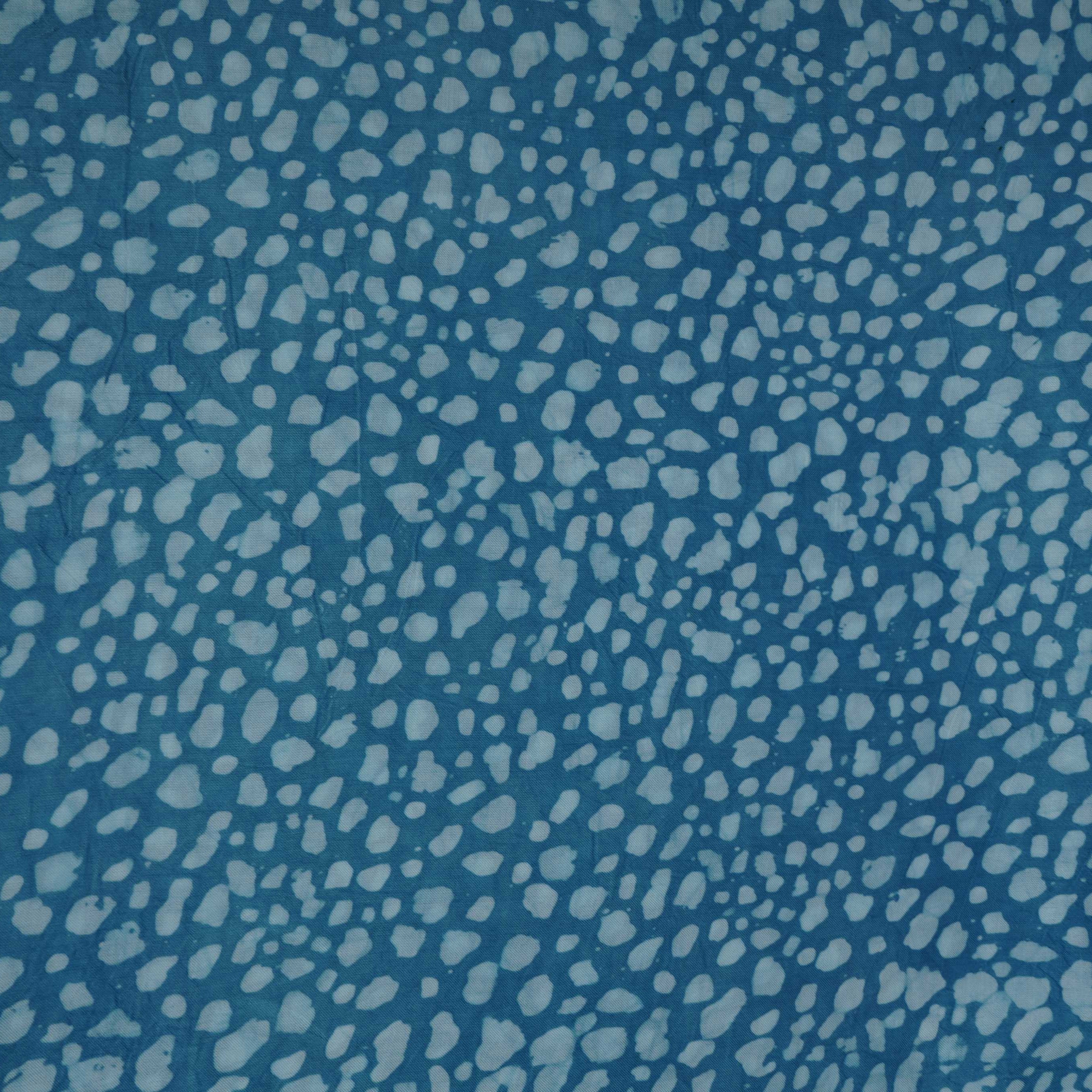 Sky blue batik print light modal satin fabric with a smooth, lustrous sheen, ideal for ethnic wear.