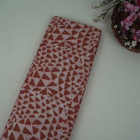Rust brown geometric batik print light modal satin fabric with a smooth, lustrous sheen, ideal for ethnic wear.