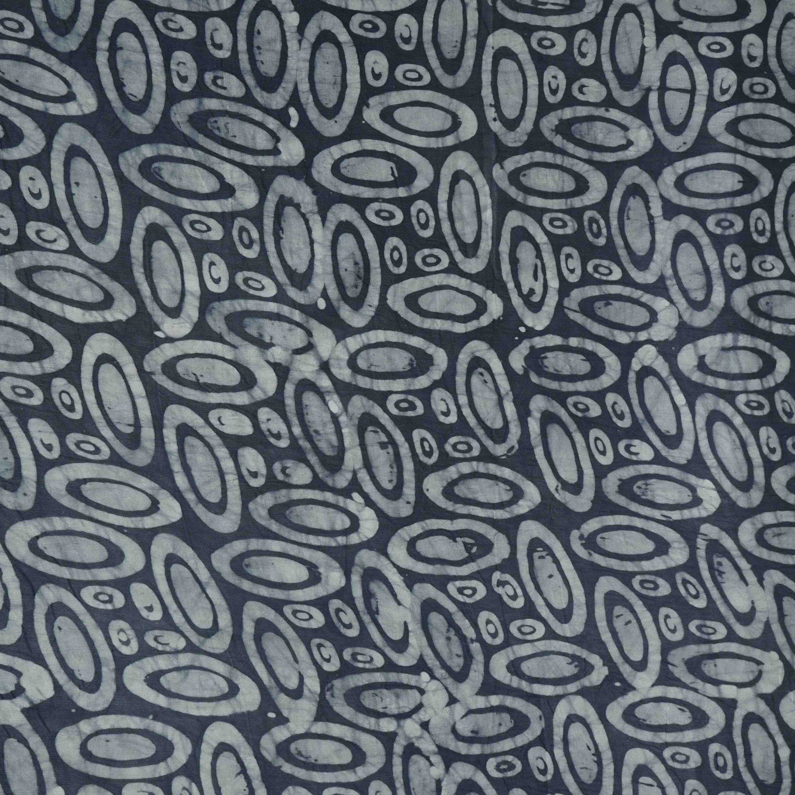 Indigo circle batik print light modal satin fabric with a smooth, lustrous sheen, ideal for ethnic wear.