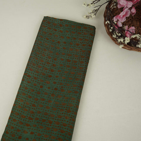 Dark green batik print light modal satin fabric with a smooth, lustrous sheen, ideal for ethnic wear.