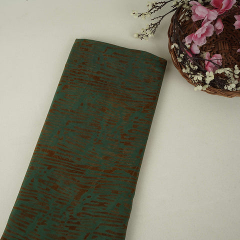 Dark green batik print light modal satin fabric with a smooth, lustrous sheen, ideal for ethnic wear.
