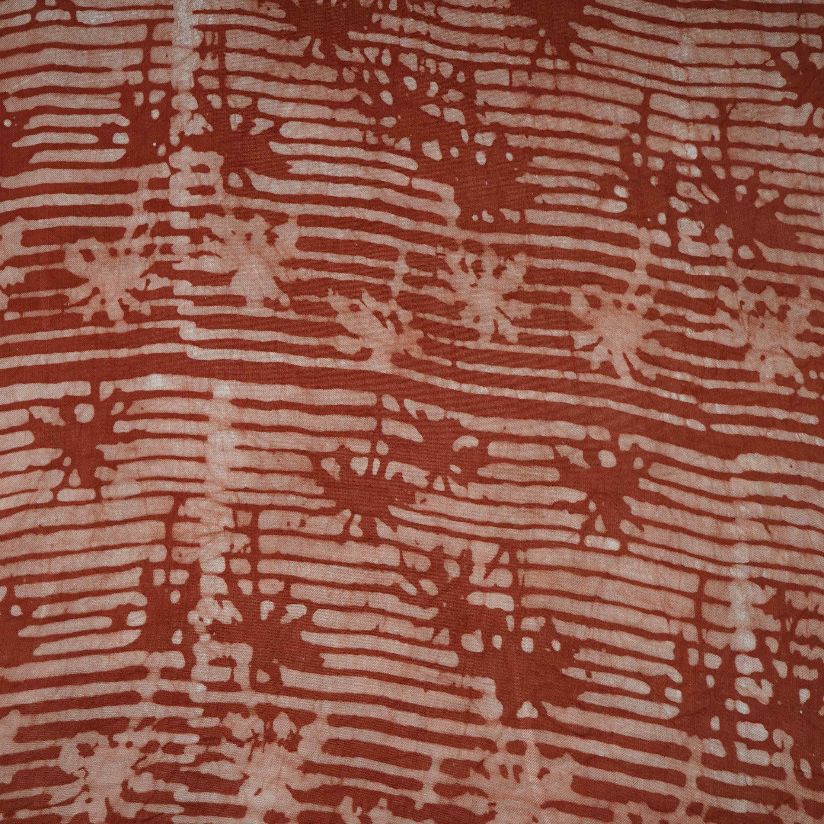 Rust brown abstract batik print light modal satin fabric with a smooth, lustrous sheen, ideal for ethnic wear.