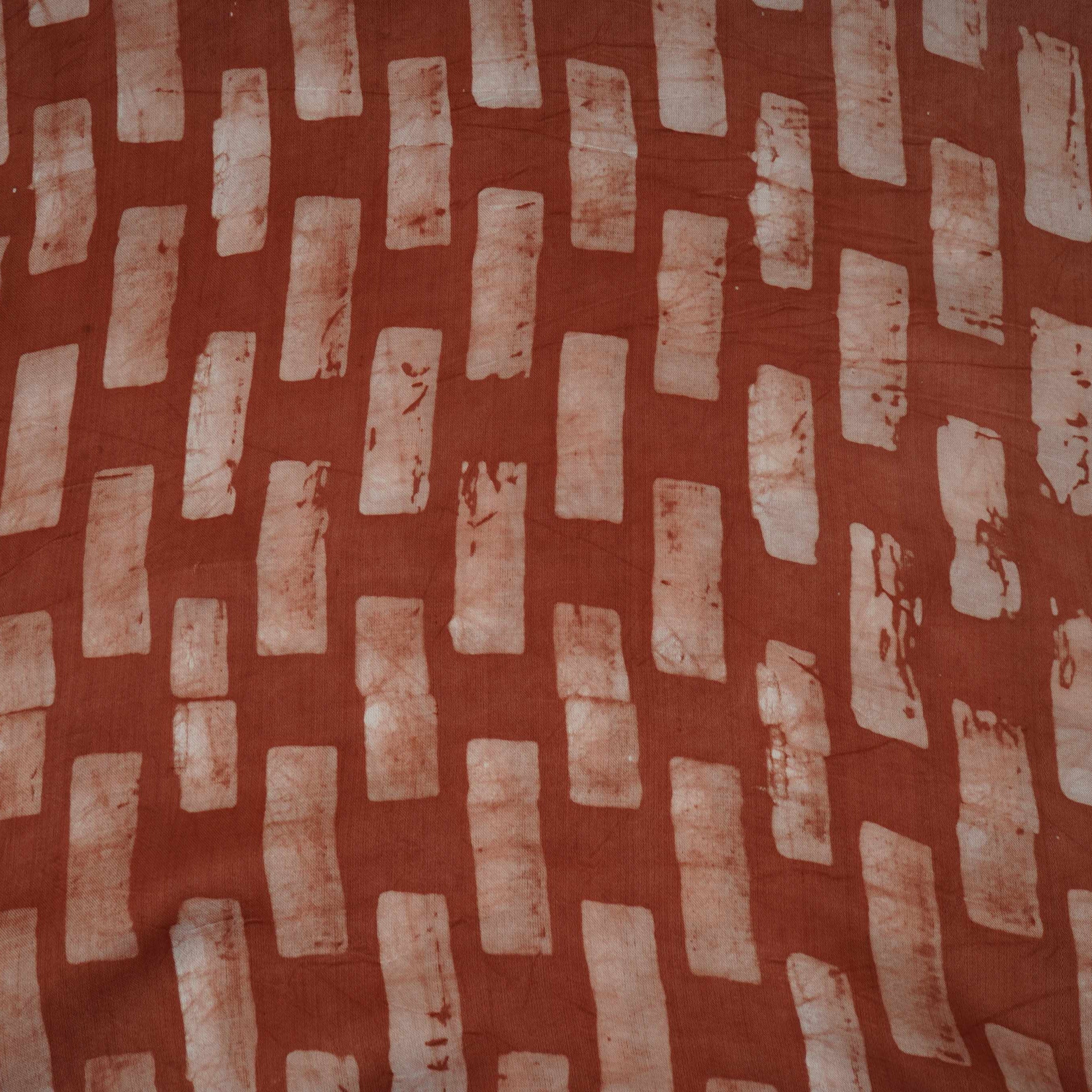 Rust brown handblock batik print light modal satin fabric with a smooth, lustrous sheen, ideal for ethnic wear.