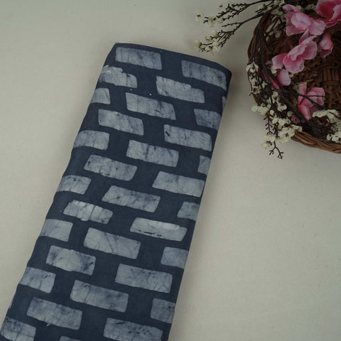 Indigo blue block batik print light modal satin fabric with a smooth, lustrous sheen, ideal for ethnic wear.