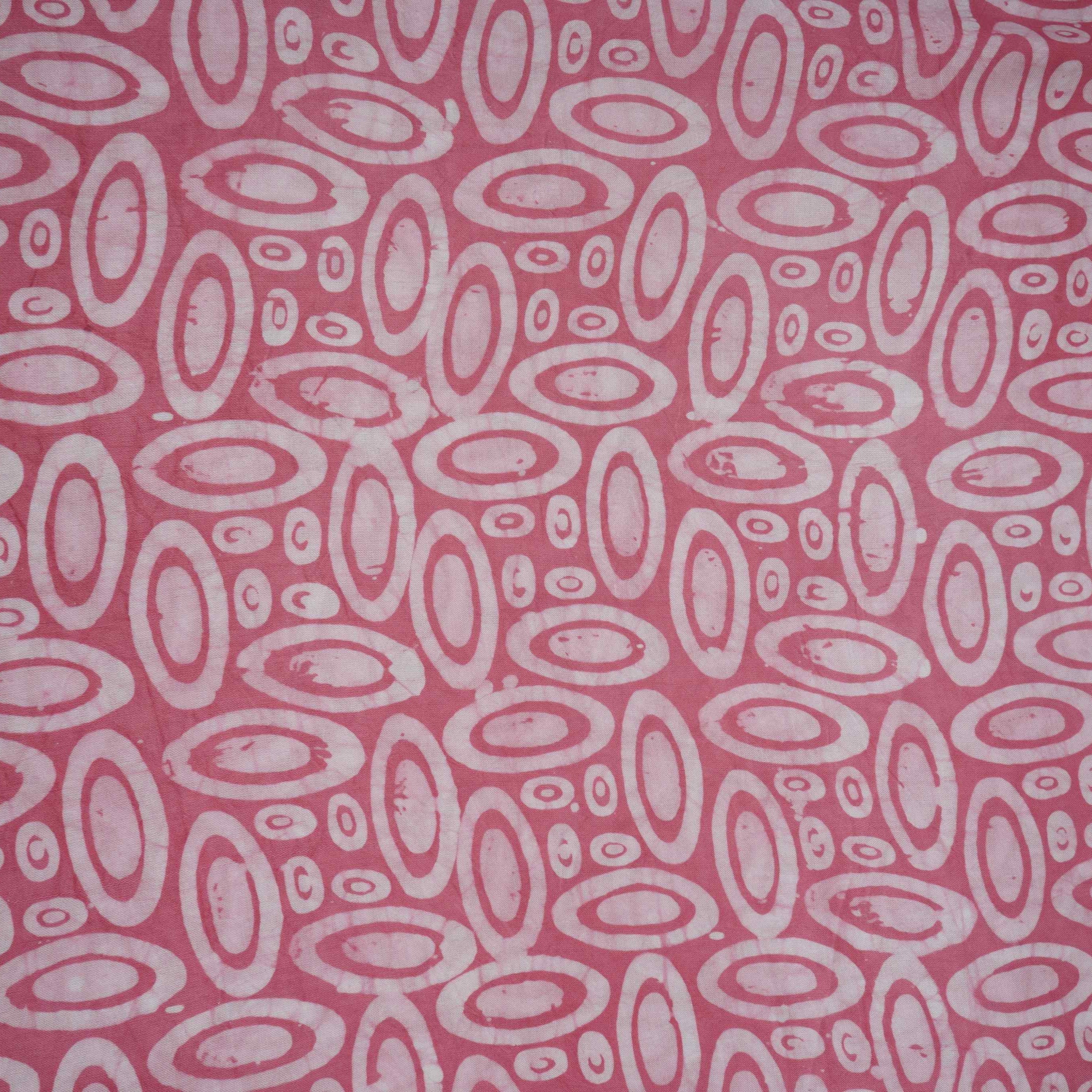Pink circle batik print light modal satin fabric with a smooth, lustrous sheen, ideal for ethnic wear.