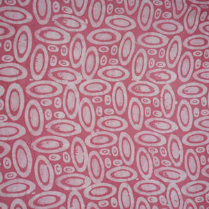 Pink circle batik print light modal satin fabric with a smooth, lustrous sheen, ideal for ethnic wear.