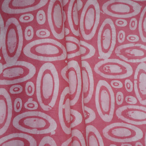Pink circle batik print light modal satin fabric with a smooth, lustrous sheen, ideal for ethnic wear.