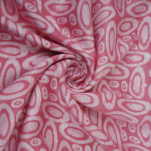 Pink circle batik print light modal satin fabric with a smooth, lustrous sheen, ideal for ethnic wear.