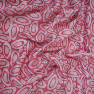 Pink circle batik print light modal satin fabric with a smooth, lustrous sheen, ideal for ethnic wear.