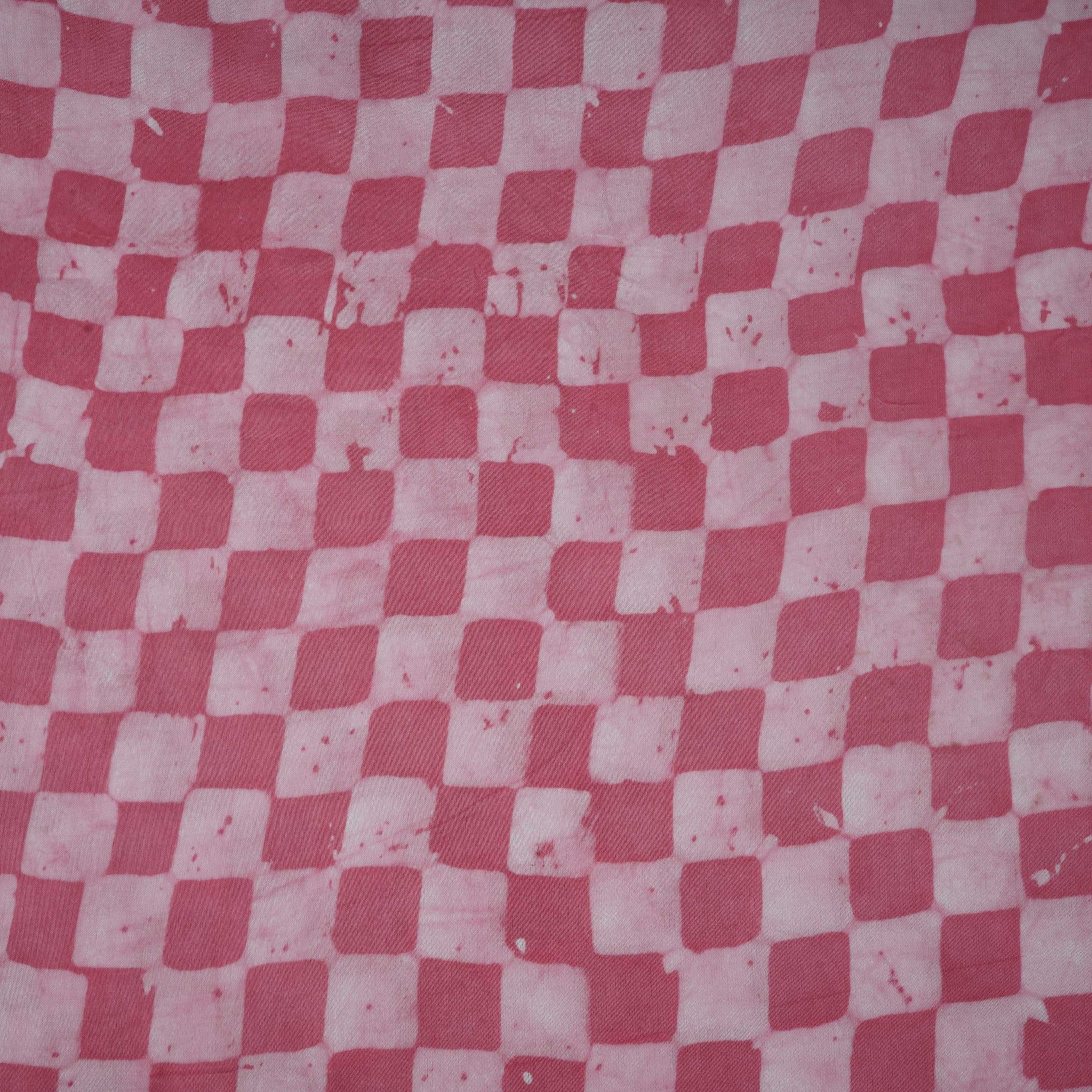 Pink geometric batik print light modal satin fabric with a smooth, lustrous sheen, ideal for ethnic wear.