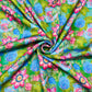 Green With Pink & Blue Floral Print Modal Satin Fabric - TradeUNO