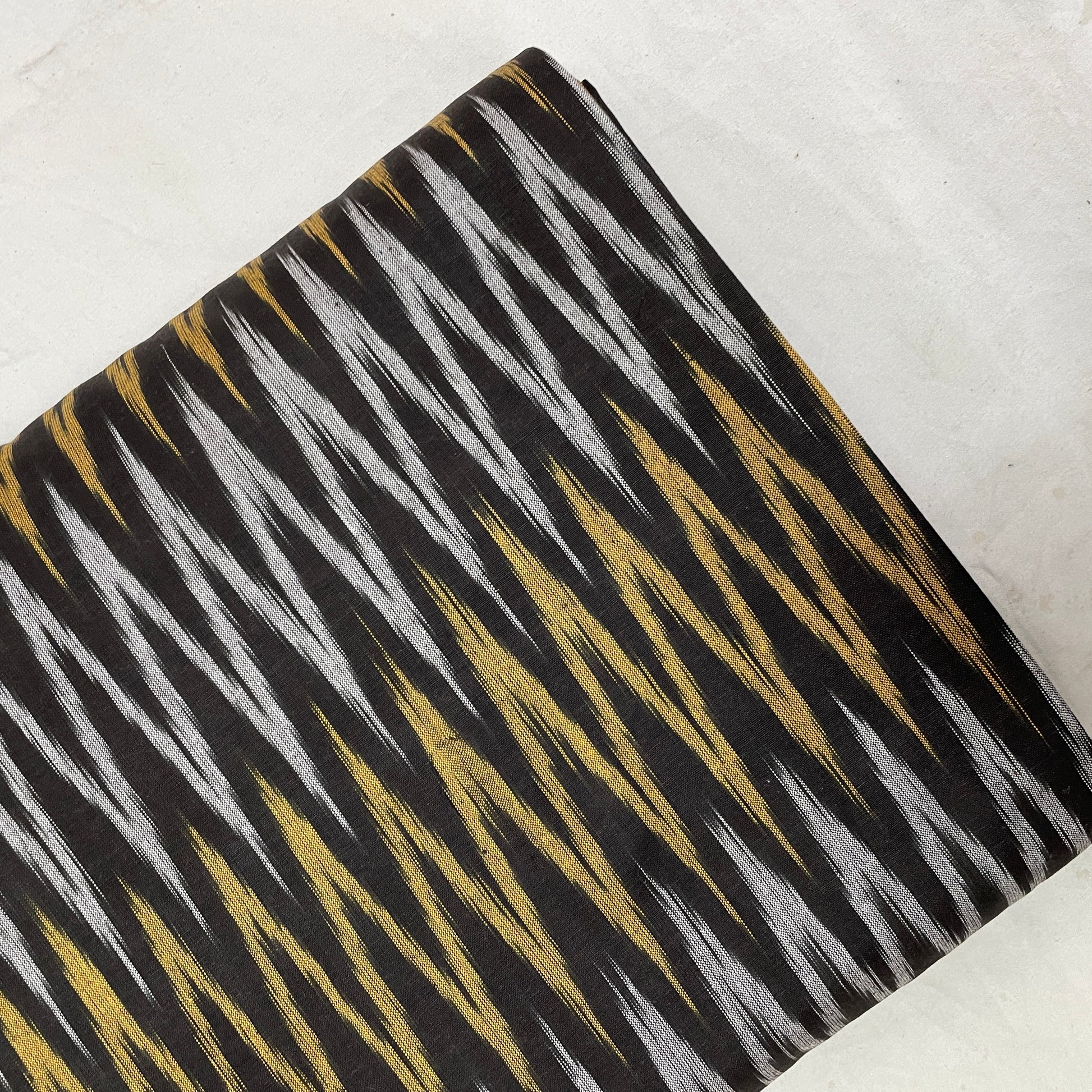 Grey With Golden Ikkat Print Cotton Fabric - TradeUNO
